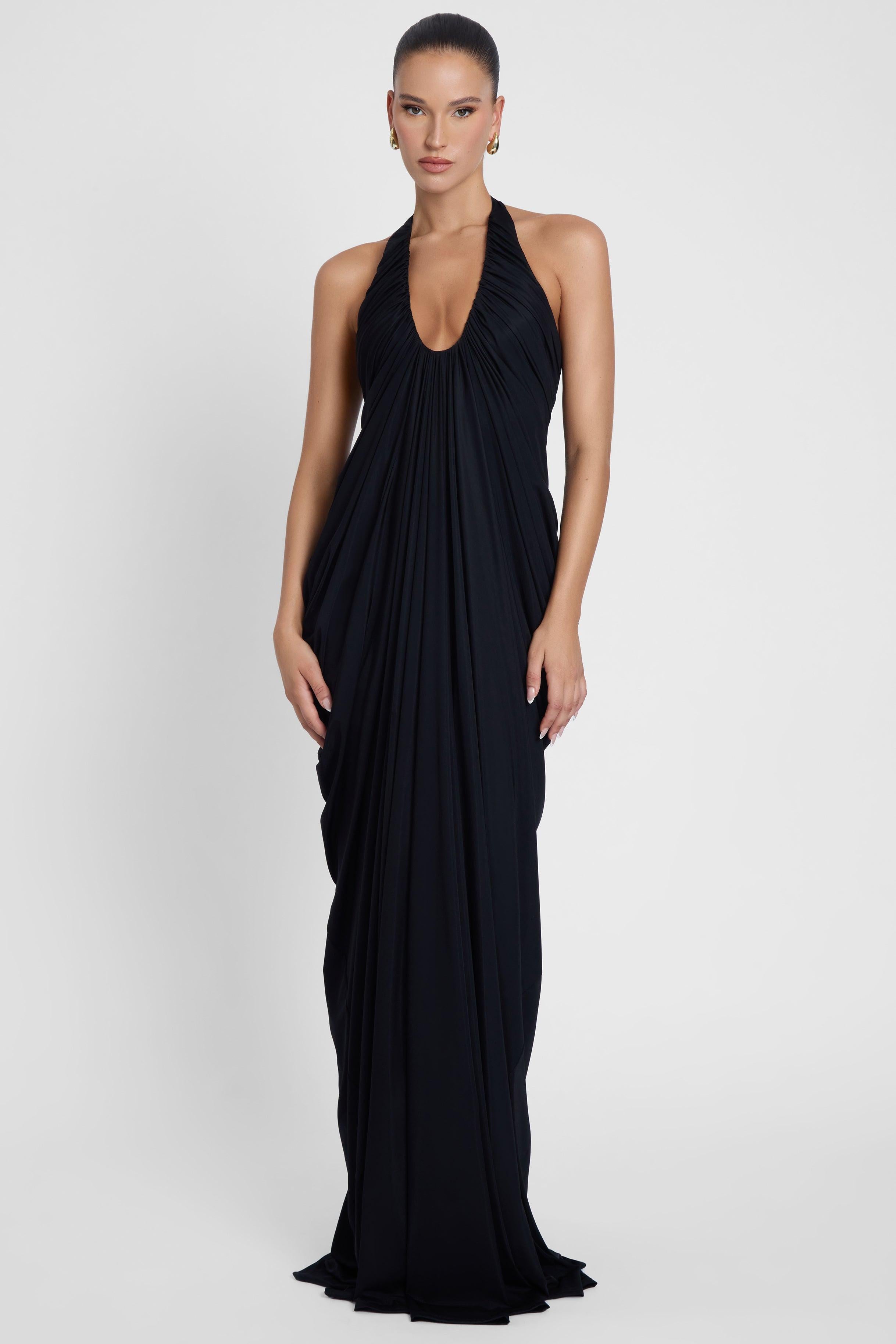 Model is wearing Cascade Drape Gown Black in Black, front view.