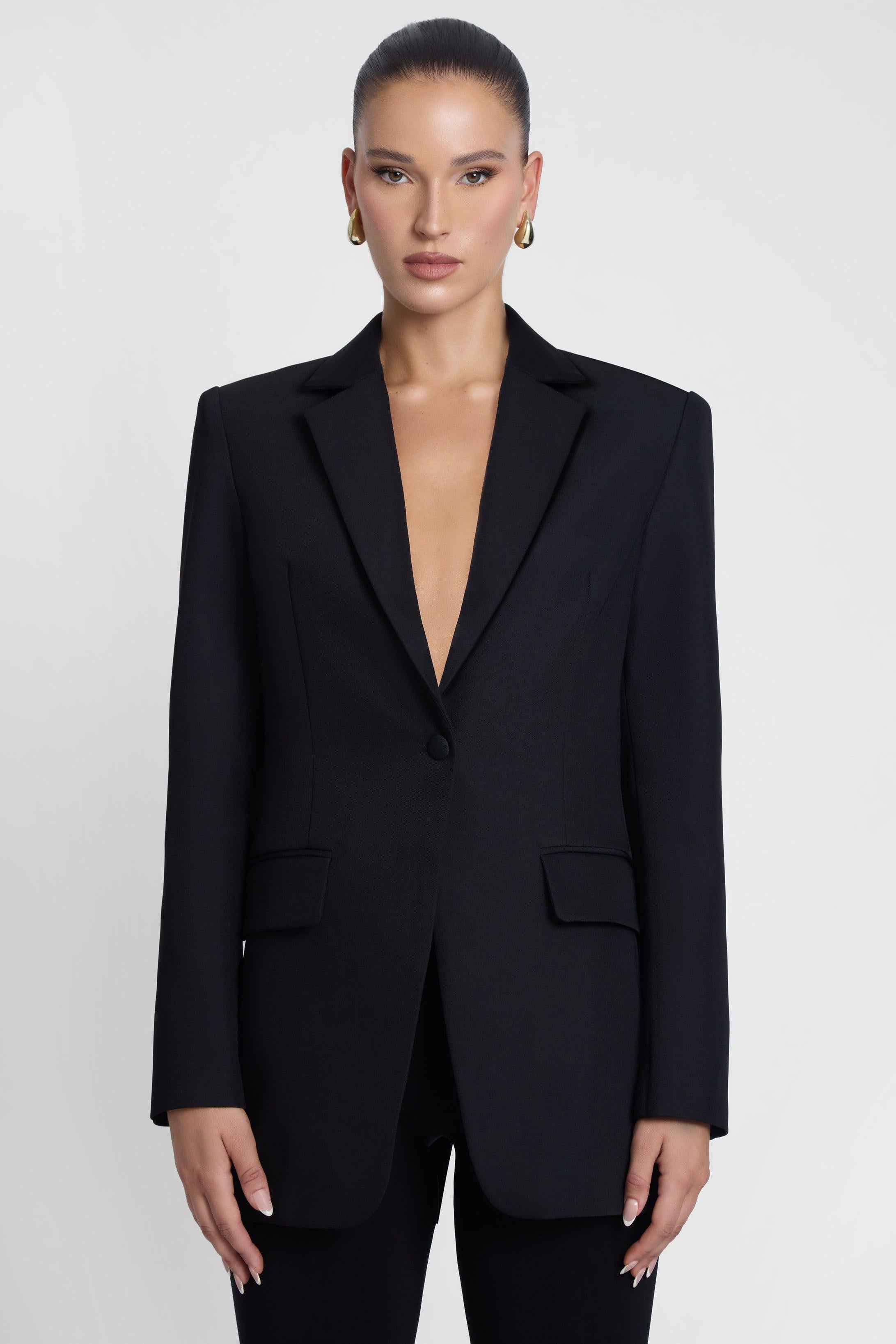 Model is wearing Classic Column Tailored Belted Blazer Black, front view.