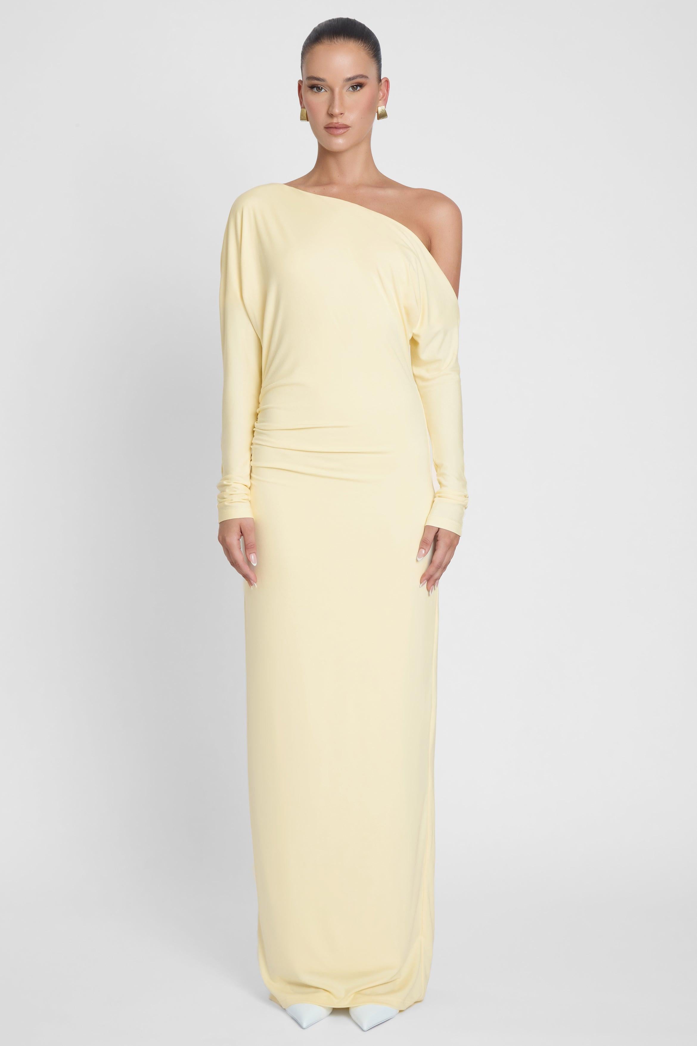 Model is wearing Sola Slouchy Jersey Maxi Dress Yellow, front view.